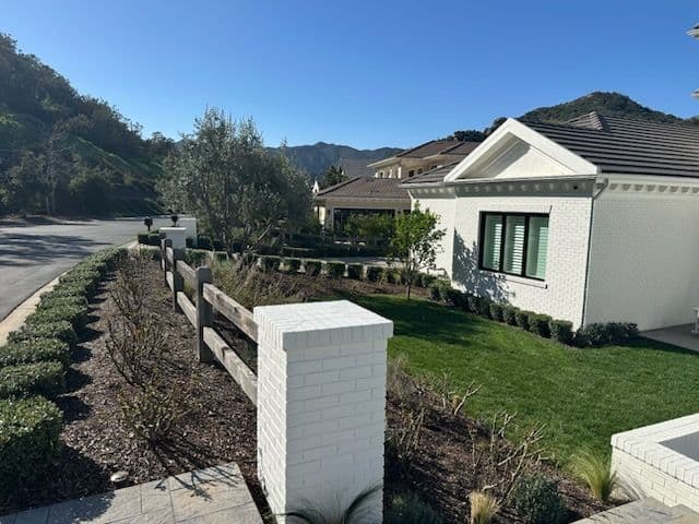 Elegant Landscape Design for Modern White Brick Home image